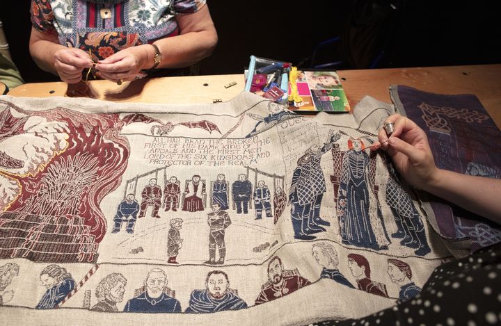 Des couturières apportent les dernières touches à la tapisserie inspirée de "Game of Thrones", à Belfast, le 5 juillet 2019 (PAUL FAITH / AFP)