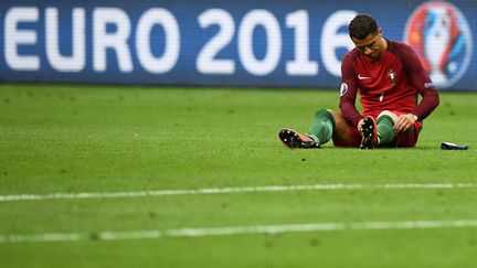 Cristiano Ronaldo, blessé, sur le terrain du Stade de France, lors de la finale de l'Euro, le 10 juillet 2016.&nbsp; (FRANCK FIFE / AFP)