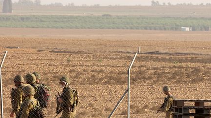 Israeli soldiers patrol near the fence of Kibbutz Nir Oz, southern Israel, November 9, 2023. (GIL COHEN-MAGEN / AFP)