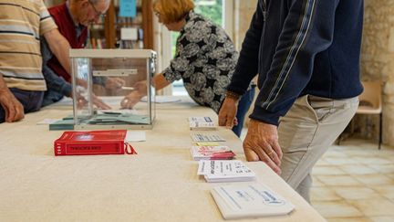 Des personnes dans un bureau de vote à Goutz, dans le Gers, le 30 juin 2024. (ISABELLE SOURIMENT / HANS LUCAS / AFP)