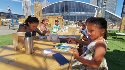 Des enfants participent à un atelier création mosaïque, au Garden Parvis, à La Défense. (LOUIS MONDOT / RADIO FRANCE)