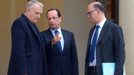 Fran&ccedil;ois Hollande (au centre), discute avec le Premier ministre Jean-Marc Ayrault (&agrave; gauche) et le ministre de l'Economie Pierre Moscovici (&agrave; droite) sur le perron de l'Elys&eacute;e, le 4 janvier 2013. (MIGUEL MEDINA / AFP)