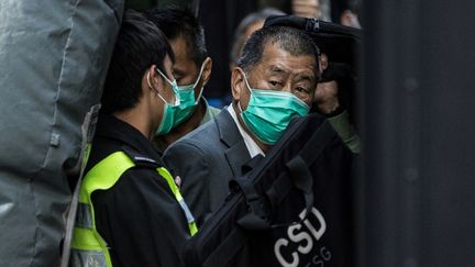 Le patron de presse Jimmy Lai entouré de policiers lors d'une audience devant la justice de Hong Kong, le 1er février 2021 (STR / AFP)