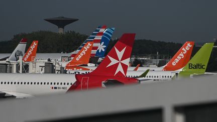 Des avions de différentes compagnies aériennes, le 14 août 2023, à l'aéroport Roissy Charles de Gaulle. (ARTUR WIDAK / NURPHOTO / AFP)