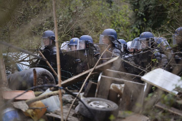 Des gendarmes derrière une barricade érigée pour protéger "Les Vraies Rouges", dans la ZAD de Notre-Dame-des-Landes (Loire-Atlantique), le 9 avril 2018.&nbsp; (GUILLAUME SOUVANT / AFP)