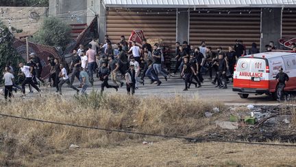 Palestinians try to escape an Israeli raid in Jenin, in the occupied West Bank, on June 19, 2023. (JAAFAR ASHTIYEH / AFP)