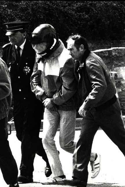 Patrick Dils est escorté par des policiers lors de la reconstitution des&nbsp;meurtres de deux garçons, Alexandre Beckrich et Cyril Beining,&nbsp;le 7 mai 1987,&nbsp;à Montigny-lès-Metz. (MAXPPP)