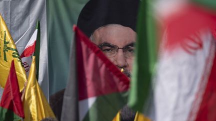 Des drapeaux palestiniens et iraniens devant un portrait de Hassan Nasrallah, à Téhéran (Iran) le 27 septembre 2024 (MORTEZA NIKOUBAZL / NURPHOTO)