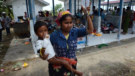 Une femme rohingya portant un enfant, à Kuala Langsa en Indonésie. Image d'illustration. (ROMEO GACAD / AFP)