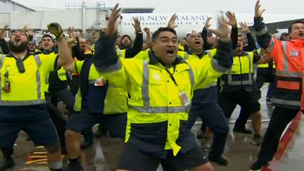 Les All Blacks accueillis par un haka du personnel de l'aéroport sur le tarmac