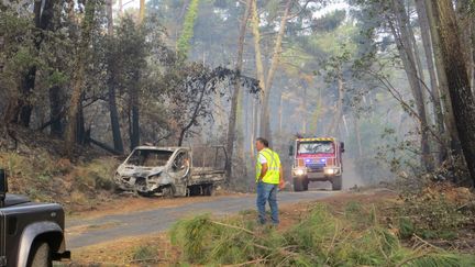 Dominique, bénévole de la Défense des forêts contre les incendies, devant la camionnette suspectée d'être à l'origine de l'incendie de la forêt usagère de La Teste-de-Buch (Gironde), le 21 juillet 2022. (MIREN GARAICOECHEA / FRANCEINFO)