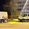 Un agent nettoie la chaussée, le 14 mars 2024, à l'endroit où a eu lieu la collision entre un scooter et une voiture de police, à Aubervillers (Seine-Saint-Denis). (WAFAA ESSALHI / AFP)