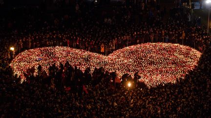 Des milliers de personnes réunies à Gdansk ont formé un coeur ave des bougies.&nbsp; (MATEUSZ SLODKOWSKI / MAXPPP)