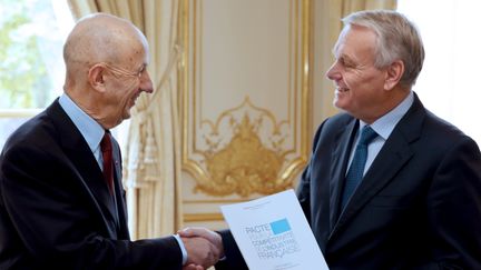 Louis Gallois (&agrave; g.) remet son rapport sur la comp&eacute;titivit&eacute; &agrave; Jean-Marc Ayrault, &agrave; l'h&ocirc;tel&nbsp;Matignon (Paris), le 5 novembre 2012. (PHILIPPE WOJAZER / AFP)