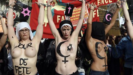 Des Femen affubl&eacute;es de signes religieux d&eacute;filent &agrave; Paris pour d&eacute;noncer la place de la femme dans les religions, le 8 mars 2015. (LOIC VENANCE / AFP)