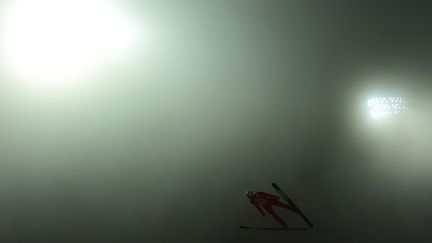 Le Polonais Dawid Kubacki s'entra&icirc;ne au saut &agrave; ski alors que la station de Sotchi est plong&eacute;e dans un &eacute;pais brouillard, le 16 f&eacute;vrier 2014. (JOHN MACDOUGALL / AFP)