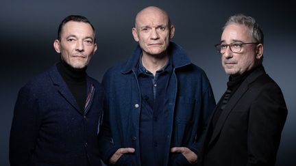 Les membres de Louise Attaque (de gauche à droite) Robin Feix, Gaëtan Roussel et Arnaud Samuel, lors d'une session photo à Paris le 22 mars 2022. (JOEL SAGET / AFP)