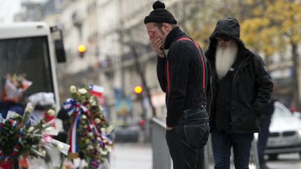 Deux membres des Eagles of Death Metal devant le Bataclan, à Paris, le 8 décembre 2015. (MIGUEL MEDINA / AFP)