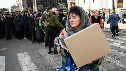 La distribution d'aide humanitaire dans une rue, à Marioupol, en Ukraine, le 19 avril 2022.&nbsp; (ILYA PITALEV / SPUTNIK / AFP)