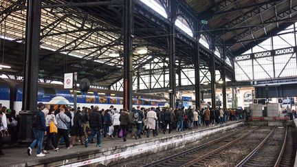 Des voyageurs sur un quai de la gare Saint-Lazare, à Paris, le 1er juin 2016. (RODRIGO AVELLANEDA / AFP)