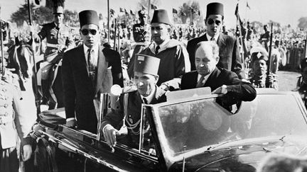 Sa Majesté le Sultan du Maroc, Sidi Mohammed Ben Youssef, à son retour d'exil le 16 novembre 1955. Au centre, il est entouré de ses fils, notamment le prince Moulay Hassan (à gauche), le futur roi Hassan II. A l'avant de la voiture, se tient son aide de camp, le général Mohamed Oufkir (à droite). (AFP)