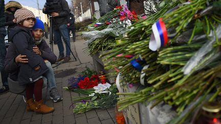 Du bleu-blanc-rouge aussi dans les rubans des bouquets de fleurs déposés devant l'ambassade de France à Moscou (Russie), samedi 14 novembre. (DMITRY SEREBRYAKOV / AFP)