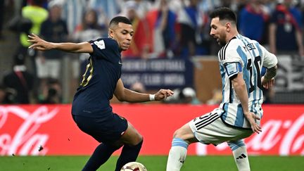 Kylian Mbappé et Lionel Messi durant la finale de Coupe du monde entre l'équipe de France et l'Argentine, le 19 décembre 2022 à Lusail. (ANNE-CHRISTINE POUJOULAT / AFP)