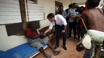 Le président Emmanuel Macron rencontrant un habitant de Saint-Martin, l'île des Antilles frappée par l'ouragan Irma, le 12 septembre 2017. (CHRISTOPHE ENA / POOL / AFP)