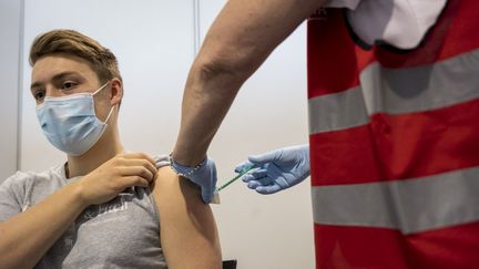 Un jeune homme reçoit une dose d'un vaccin contre le Covid-19, le 19 mai 2021, à Hanau (Allemagne). (THOMAS LOHNES / AFP)