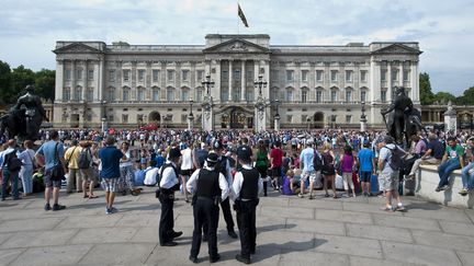 Des policiers et des touristes devant&nbsp;Buckingham Palace &agrave; Londres (Grande-Bretagne), le 23 juillet 2013. (WILL OLIVER / AFP)