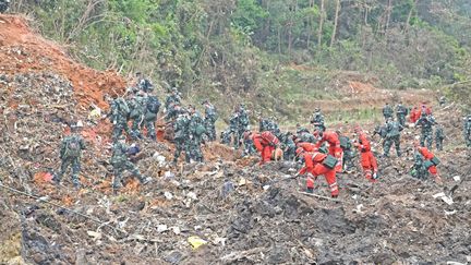 Des sauveteurs recherchent les boîtes noires après le crash d'un avion de la China Eastern Airlines dans le comté de Tengxian&nbsp;(Chine), le 22 mars 2022. (ZHOU HUA / XINHUA)