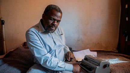 Contraint de rester confiné dans sa chambre, il profite de ses longues semaines d'enfermement pour rédiger ses mémoires. Jour après jour, il frappe sur les touches en braille de sa machine à écrire pour raconter les grandes étapes de son existence.&nbsp; &nbsp; &nbsp; (LUCA SOLA / AFP)