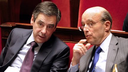 Fran&ccedil;ois Fillon, premier ministre, et Alain Jupp&eacute;, ministre des Affaires &eacute;trang&egrave;res, le 6 d&eacute;cembre 2011, &agrave; l'Assembl&eacute;e nationale, &agrave; Paris. (BERTRAND GUAY / AFP)