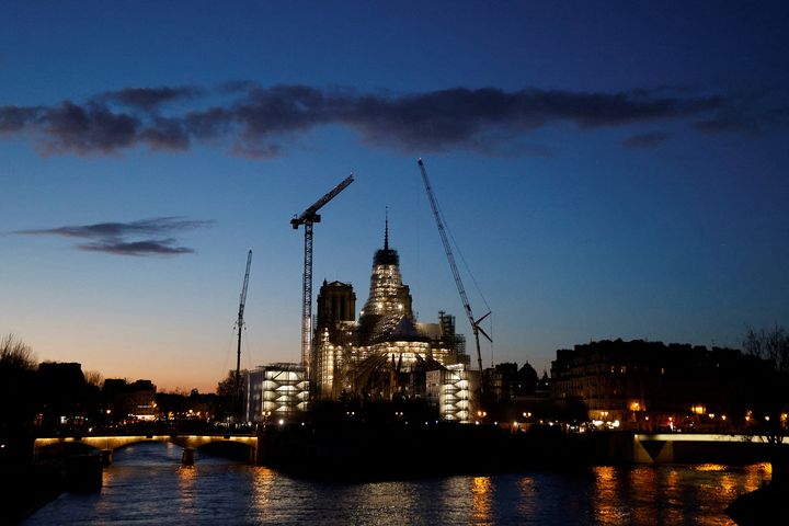 Le chantier illuminé de la cathédrale Notre-Dame de Paris, le 12 février 2024. (LUDOVIC MARIN / AFP)