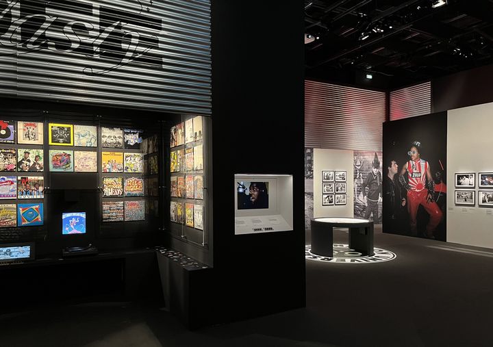 Vue générale des premiers espaces du parcours de l'exposition "Hio-Hop 360" à la Philharmonie de Paris, avec la Zulu Nation à droite, et à&nbsp;gauche le corner dédié à la collection de vinyles de la légende Dee Nasty. (LAURE NARLIAN / FRANCEINFO)