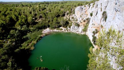 Des personnes se baignent dans le gouffre de l'&OElig;il doux, dans le massif de la Clape (Aude), le 31 juillet 2012.&nbsp; (RAYMOND ROIG / AFP)