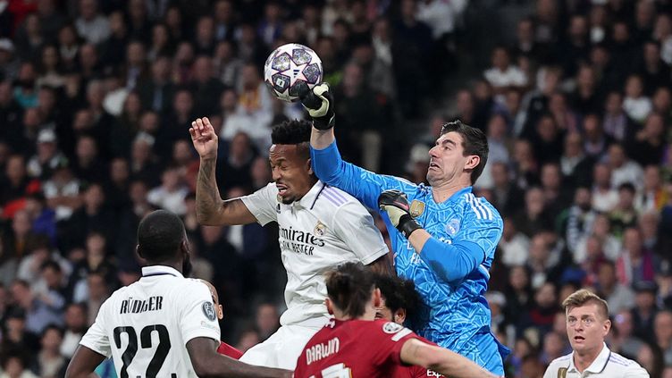 Thibaut Courtois clears the ball with his fist in the knockout stages of the Champions League, Wednesday March 15, against Liverpool.  (PIERRE-PHILIPPE MARCOU / AFP)