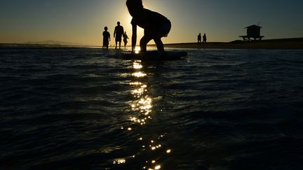 Los Angeles (Californie), 33 &deg;C, le 9 juillet 2012. Une petite fille s'essaie au surf sur Seal Beach. (FREDERIC J. BROWN / AFP)