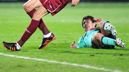 Messi au sol (ALEXANDER NEMENOV / AFP)