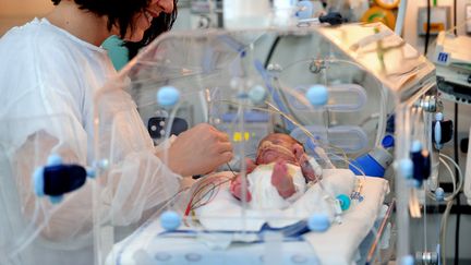 Une infirmi&egrave;re s'occupe d'un nouveau-n&eacute; dans le service n&eacute;onatal du Centre hospitalier de Lens (Pas-de-Calais), le 4 d&eacute;cembre 2013. (PHILIPPE HUGUEN / AFP)