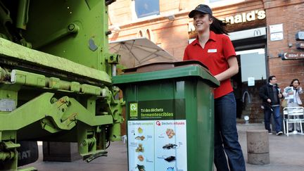 Une employée d'un fast-food sort les poubelles, à Toulouse en avril 2012.&nbsp; (THIERRY BORDAS / MAXPPP)