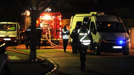 Des gendarmes et pompiers &agrave; Garons (Gard), devant la maison o&ugrave; ont &eacute;t&eacute; d&eacute;couverts cinq morts, le 21 janvier 2013. (PASCAL GUYOT / AFP)