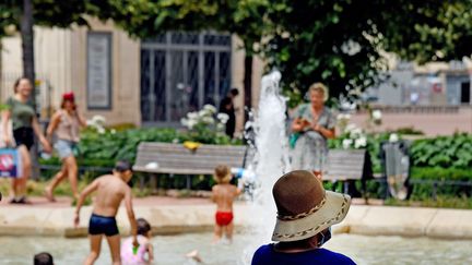 Les&nbsp;enfants se jettent à l'eau dans les bassins de la place Bellecour pour trouver un peu de fraicheur, le 19 juin 2021 à Lyon. (RICHARD MOUILLAUD / MAXPPP)