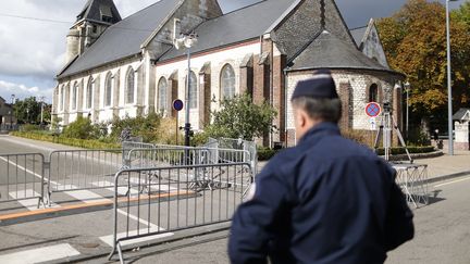 Un policier devant l'église de&nbsp;Saint-Etienne-du-Rouvray, le 2 octobre 2016. (CHARLY TRIBALLEAU / AFP)