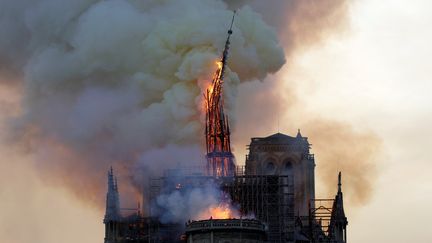 Vers 19h50, la flèche de la cathédrale, haute de 93 mètres, s'écroule.&nbsp;Des cris de stupeur des badauds et des pleurs s'élèvent.&nbsp; (GEOFFROY VAN DER HASSELT / AFP)