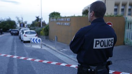 Un policier aux abords de l'h&ocirc;pital de l'Archet, &agrave; Nice (Alpes-Maritimes), le 6 mai 2014, apr&egrave;s une fusillade visant l'h&eacute;riti&egrave;re mon&eacute;gasque H&eacute;l&egrave;ne Pastor et son chauffeur. (VALERY HACHE / AFP)