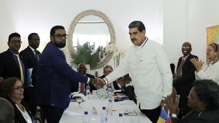 Guyana's President Irfaan Ali and his Venezuelan counterpart Nicolas Maduro shake hands on December 14 in Saint Vincent and the Grenadines.  (MARCELO GARCIA / VENEZUELAN PRESIDENCY / AFP)