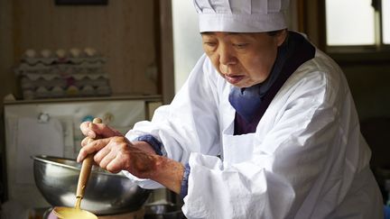 Dans le film de Naomi Kawase, elle interprète le rôle d'une vieille cuisinière, abîmée par la lèpre, qui vient en aide à un cuisinier désabusé.
