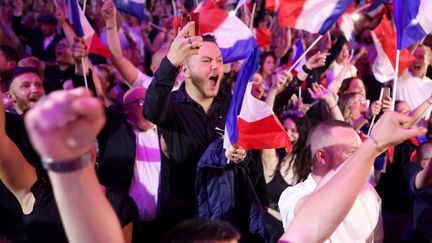 Supporters of the National Rally during the announcement of the results of the first round of the legislative elections, June 30, 2024, in Hénin-Beaumont (Pas-de-Calais).  (FRANCOIS LO PRESTI / AFP)