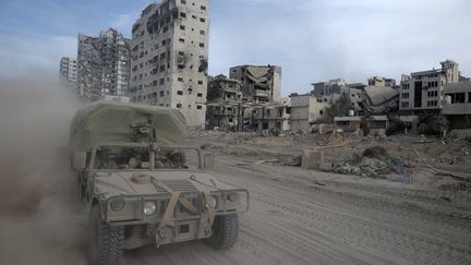 Israeli troops drive a vehicle in the northern Gaza Strip, amid fighting, November 22, 2023. (AHIKAM SERI / AFP)